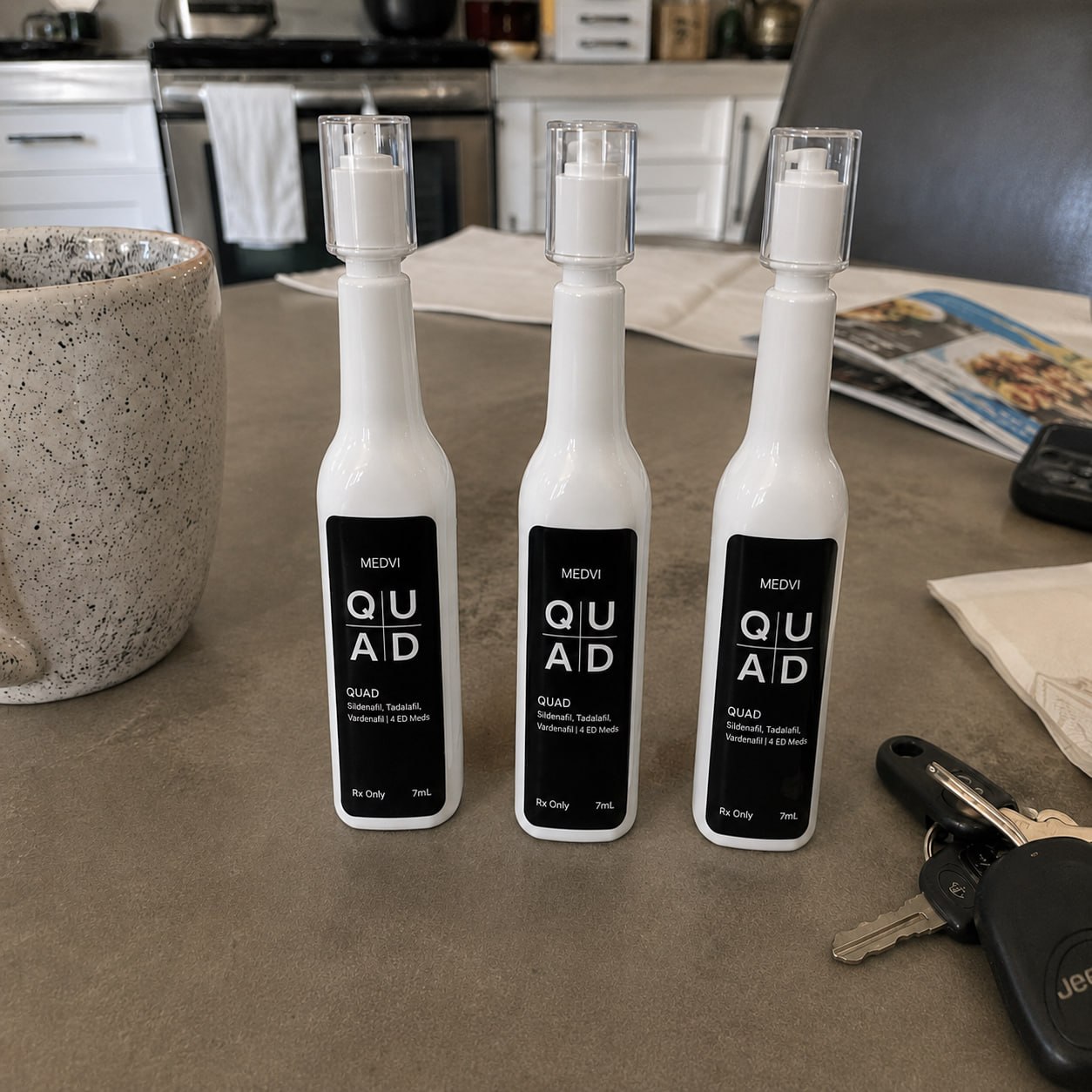 Three MEDVI QUAD sublingual bottles on a kitchen counter